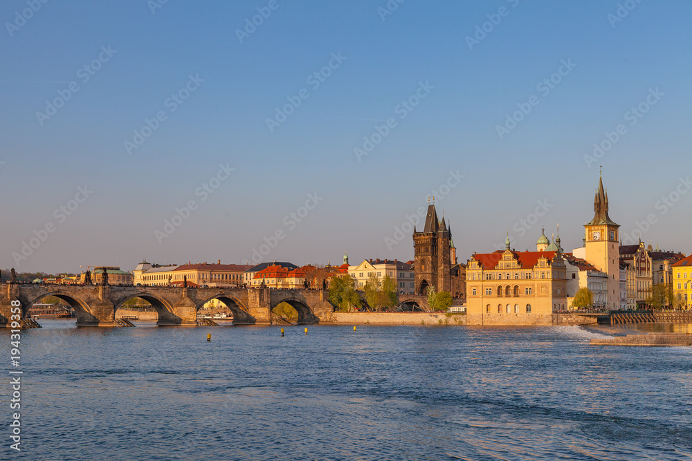 Sunset over Charles Bridge and old town of Prague, Czech Republic. Beautiful summer moments.