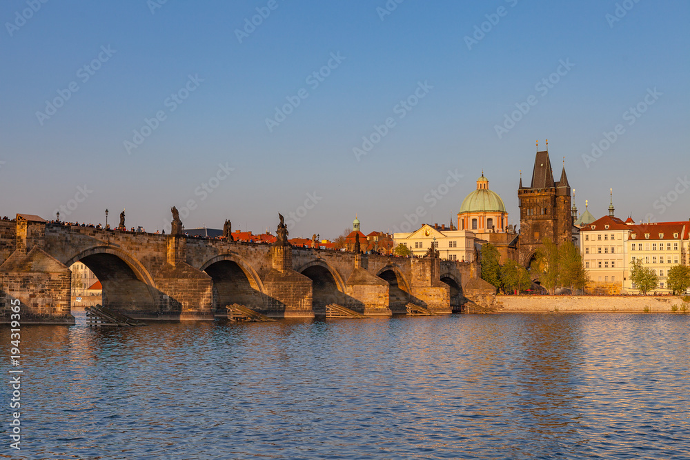 Sunset over Charles Bridge and old town of Prague, Czech Republic. Beautiful summer moments.