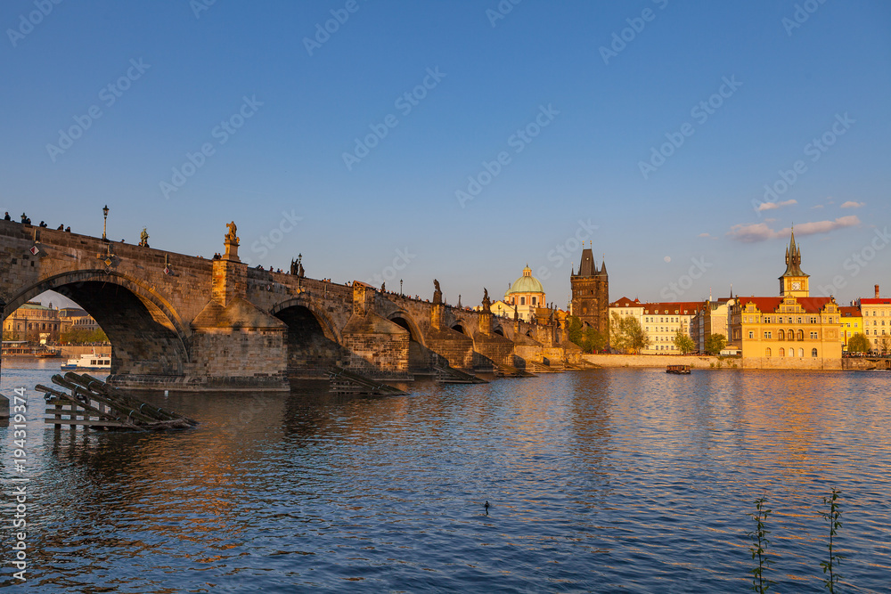 Sunset over Charles Bridge and old town of Prague, Czech Republic. Beautiful summer moments.