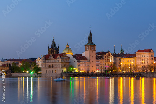 Scenic summer evening view of the Old Town ancient architecture and Vltava river pier in Prague, Czech Republic