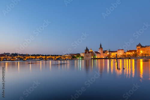 Scenic summer evening view of the Old Town ancient architecture and the Charles bridge over Vltava river in Prague, Czech Republic