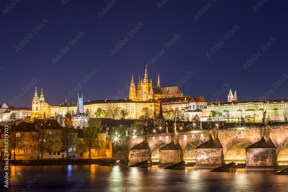 Amazing night view of Hradcany (Prague Castle) with St. Vitus Cathedral and Charles bridge at night, Bohemia landmark. Prague, Czech Republic.