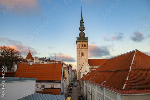 Old Tallinn architecture ensemble. Aerial view of towers, red roofs of medieval church