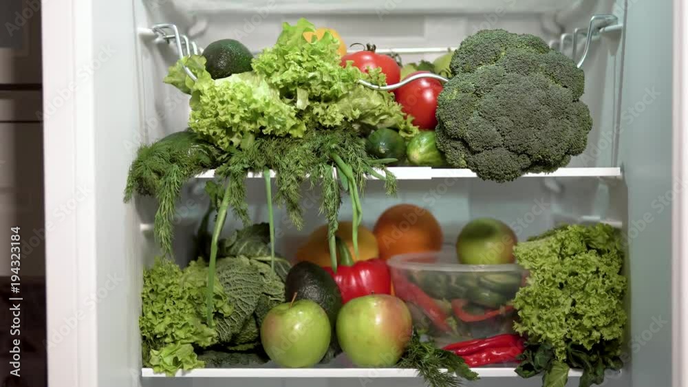Closeup of full fridge, fresh and colorful vegetables in the refrigerator, rich nutrition food