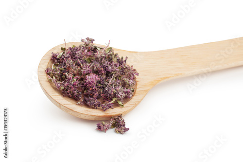 Dried thyme herbs in wooden spoon isolated on white background.