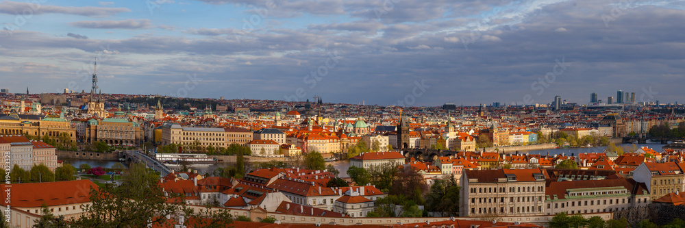 Sunset view of old town skyline with bridges and Vltava river from Hradcany castle. Skyline of Prague, Czech Republic. Wide panorama.