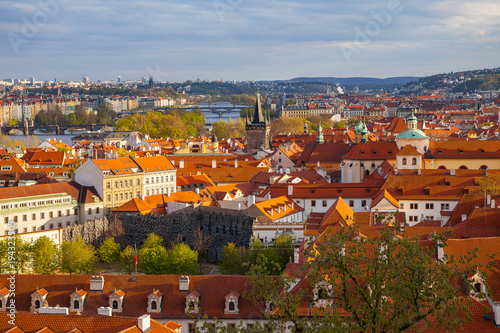 Bright sunset view of old town skyline with bridges and Vltava river from Hradcany castle. Skyline of Prague, Czech Republic