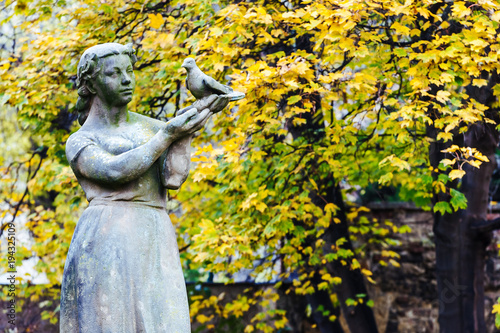 Statue of woman with bird in her hand in europe