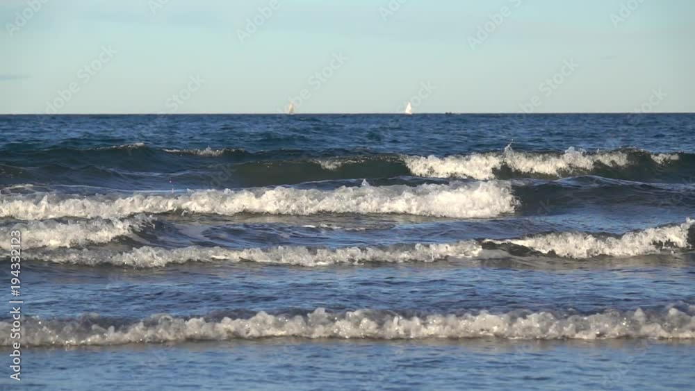 sea waves breaking in slow motion, relaxing background, horizon line with sailboats sea waves breaking in slow motion, relaxing background, horizon line with sailboats