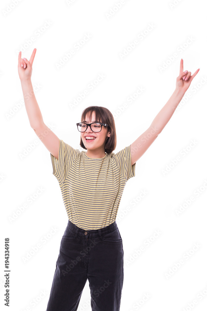 Fashion teen girl hipster giving the Rock and Roll sign . Pretty models smiling on white background Fashion teen girl hipster giving the Rock and Roll sign . Pretty models smiling on white background