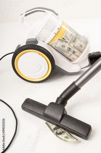 Yellow-colored vacuum cleaner with a brush sucks US dollars. Concept to succeed in business. White background