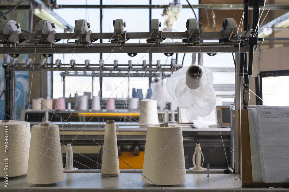 Fototapeta premium Spools with thread at rewinding machine