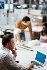 Multiracial team working in design and engineering architecture office.