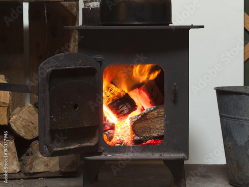 small log burner with door open and 