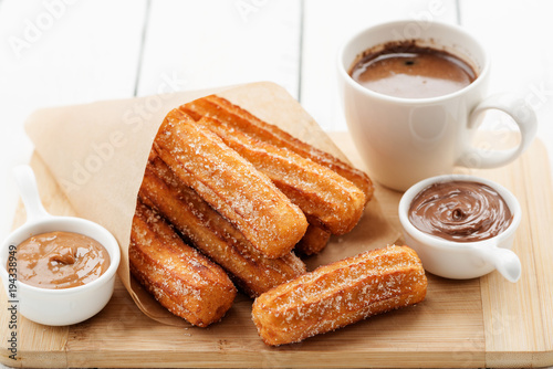 Churros with sugar and chocolate sauce . top view 