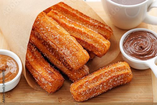 Churros with sugar and chocolate sauce . top view  photo