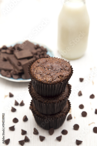 Whole Wheat Double Chocolate Chip Muffins on a Rustic White Wood Table