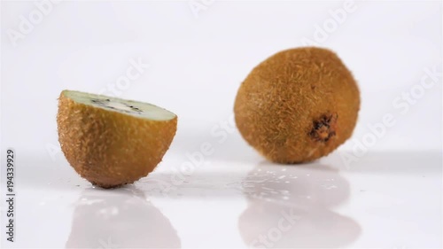 Close up kiwi fruit cut in half macro studio drop photo