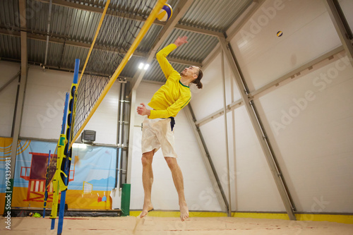 volleyball player in the indoor gym with sand.