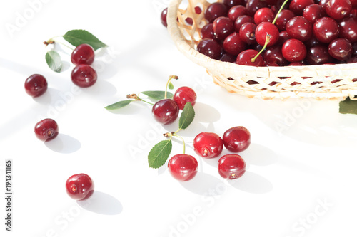 Fresh fruit cherry  in  wicker basket  on white background. Red berry still life