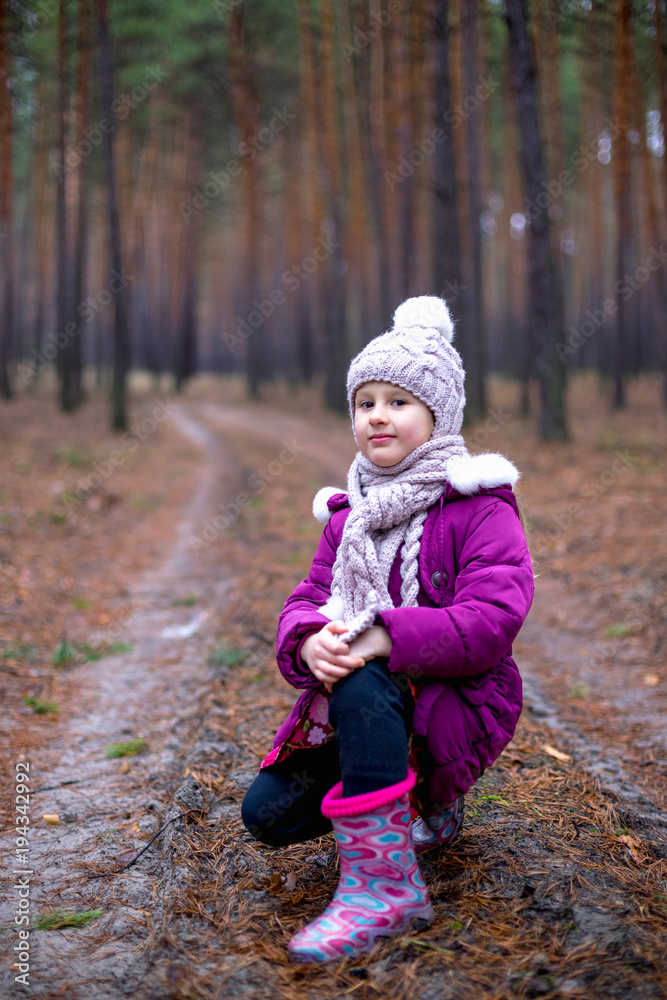 Little cute little girl posing on the road in the autumn forest Little cute little girl posing on the road in the autumn forest