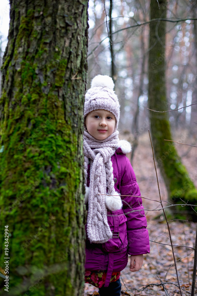 Cute little girl posing in autumn forest