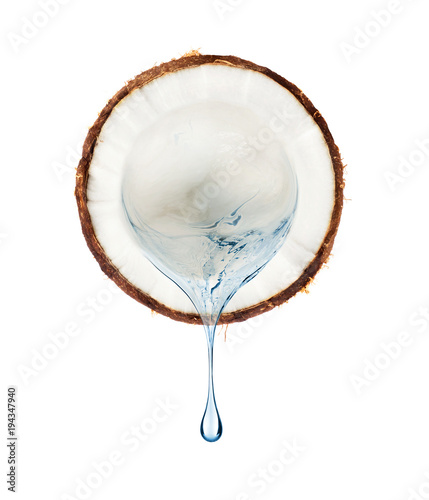 Juice flows from a slice of coconut on a white background