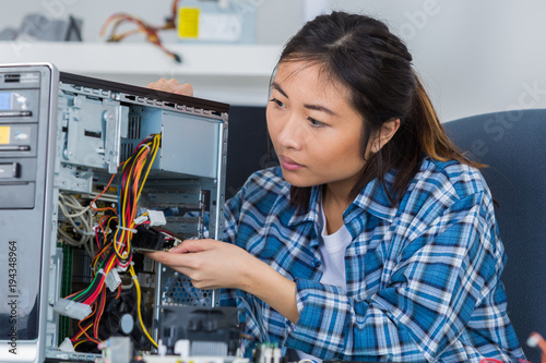 asian lady repairing computer