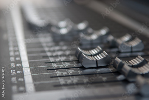 Fotografija Close up professional studio mixing console fader in grey
