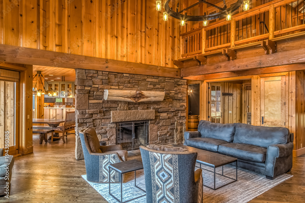 Upscale rustic living room with stone fireplace - obrazy, fototapety, plakaty 