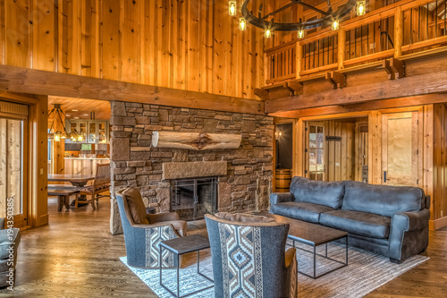 Upscale rustic living room with stone fireplace