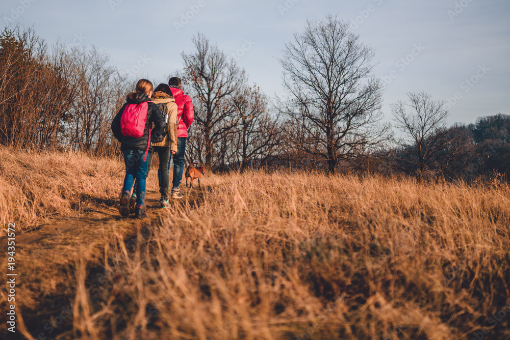 Family hiking at mountain with dog