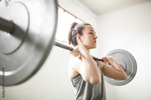 woman training with weight bar photo