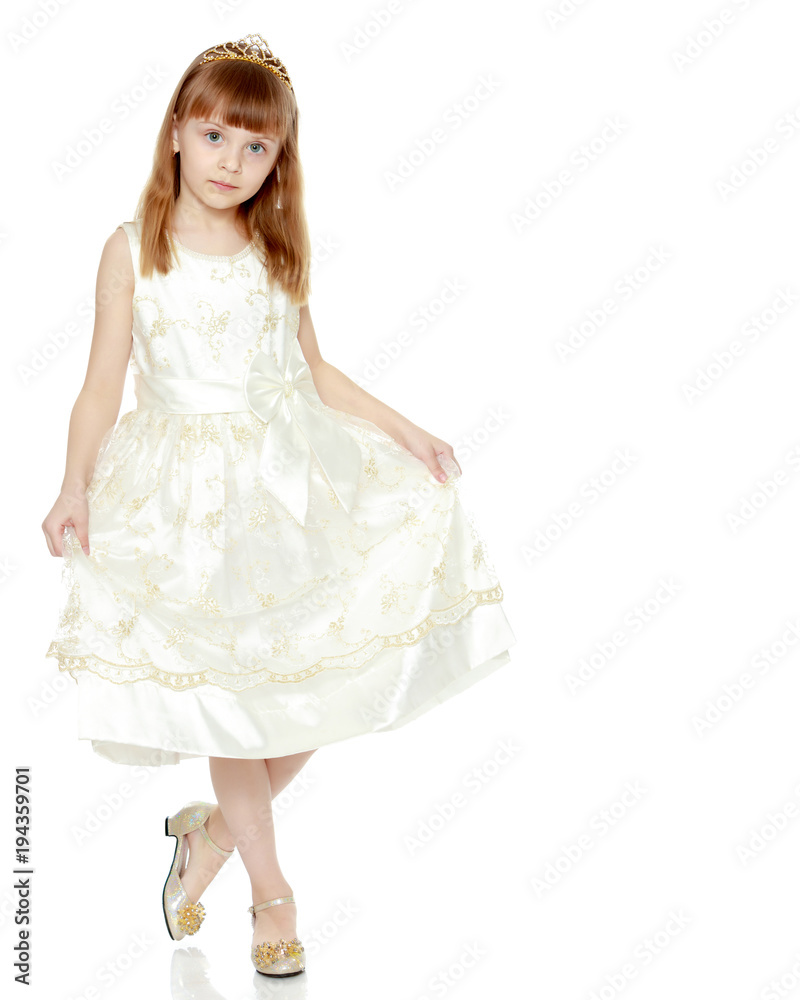 The girl is holding the edges of the dress with her hands. The girl is holding the edges of the dress with her hands.