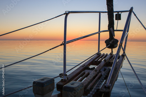 A sunrise view off the bow of a sailboat cruising through the Exumas Island chain in the Bahamas.