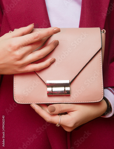 Fashionable girl  with  handbag close up. Stylish accessory.