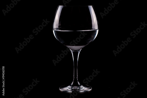 Red wine glass silhouette on black background