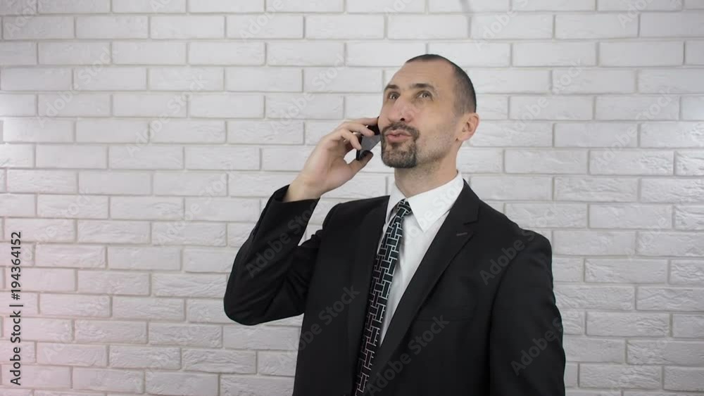 Businessman talking on the phone. A happy person phone enjoys the falling money. Businessman talking on the phone. A happy person phone enjoys the falling money.