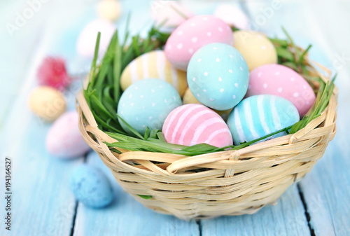 Pastel painted decorated eggs on flower background, Easter holiday decor card, selective focus, shallow DOF, toned