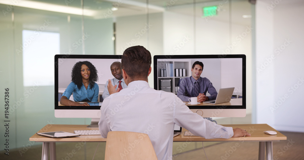 Diverse group of business associates having internet based web conference over video chat. Black Hispanic and Caucasian team of professionals communicating using modern technology