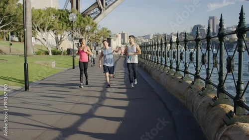 Group of young joggers finish their run and start talking to each other