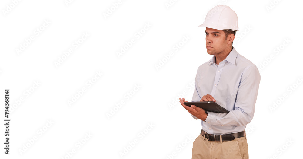 Millennial Latino architect on white backdrop with copy space wearing hard hat. Hispanic job foreman using tablet computer and helmet. Background with Copyspace 4k Millennial Latino architect on white backdrop with copy space wearing hard hat. Hispanic job foreman using tablet computer and helmet. Background with Copyspace 4k