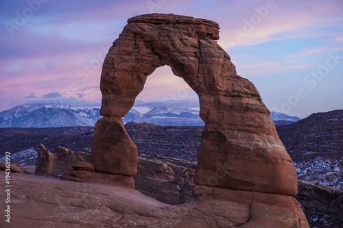 Sunset colors behind Delicate Arch