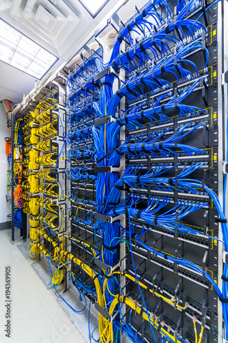 Rack with generic ethernet cat5e cables, part of a large company data center.