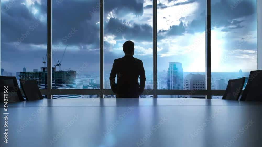 Executive looking at city for analyze something.