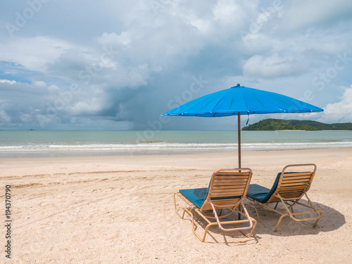 Fototapeta Naklejka Na Ścianę i Meble -  Beach Chair and Blue Umbrella in Sunny Day