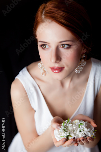 woman with breautiful earrings and flowers photo