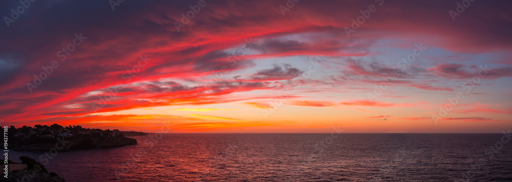 Drone aerial view of a Fiery sunrise with multicolored clouds. Mallorca Island, Spain. Summer season