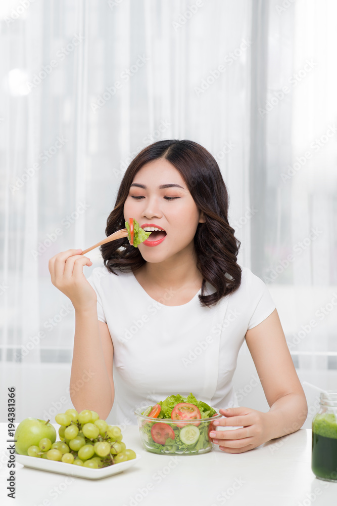 Young woman eating salad. Weight loss concept