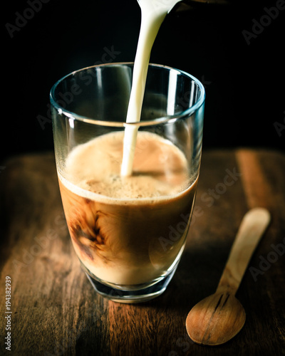 pouring milk into latte